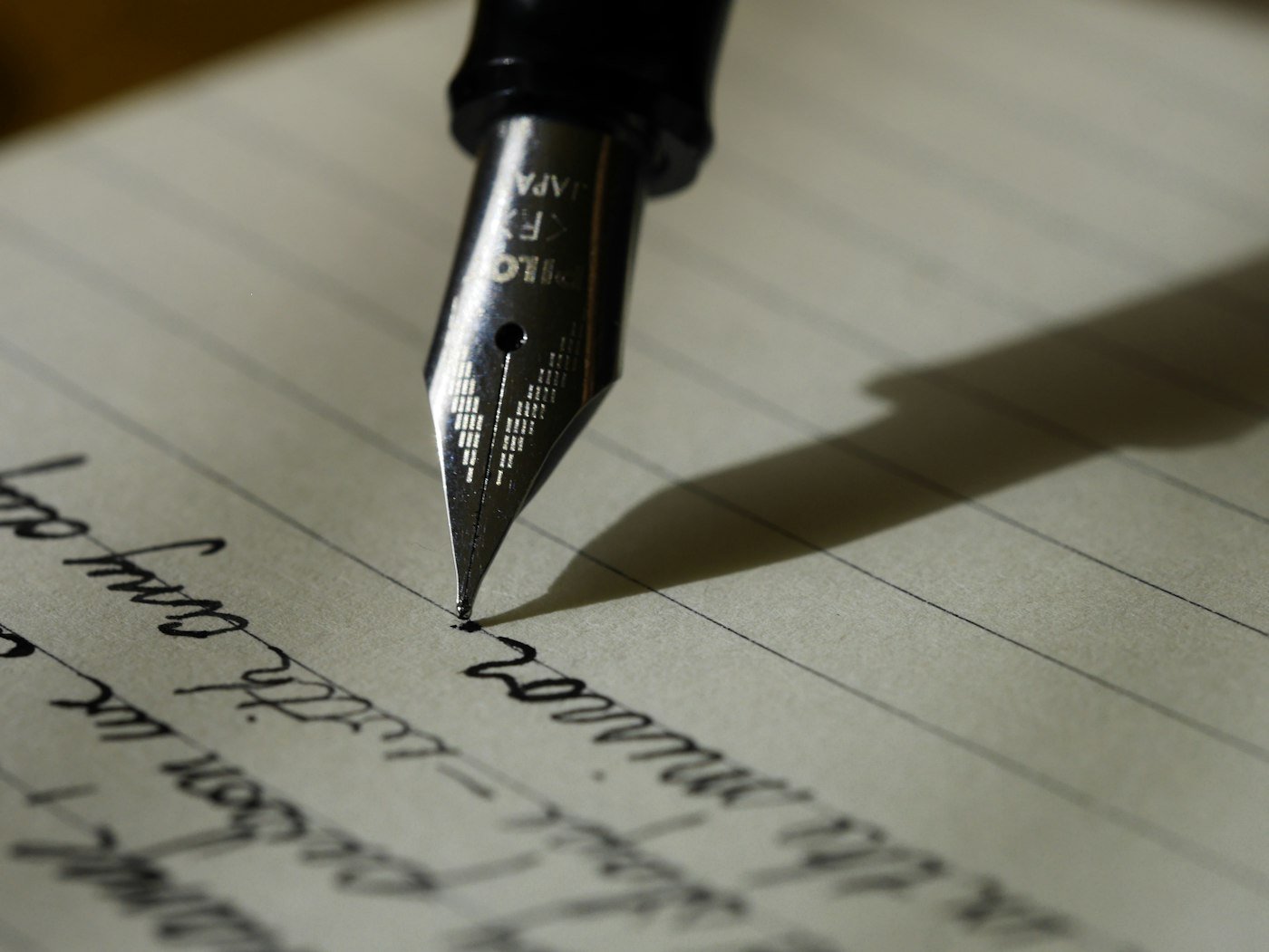 Fountain pen on lined paper, drafting an SEO title