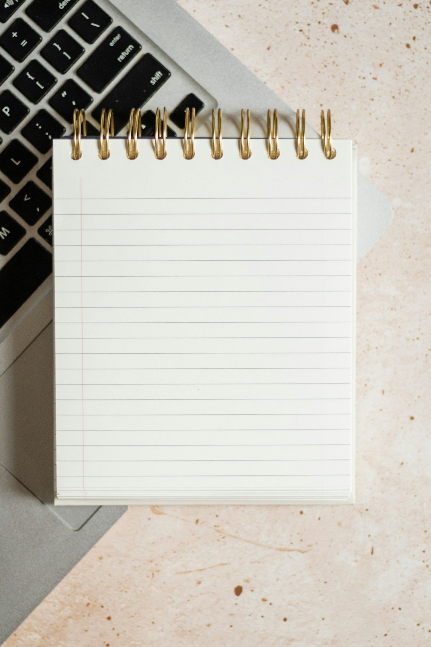 Notepad on a laptop for planning keyword research