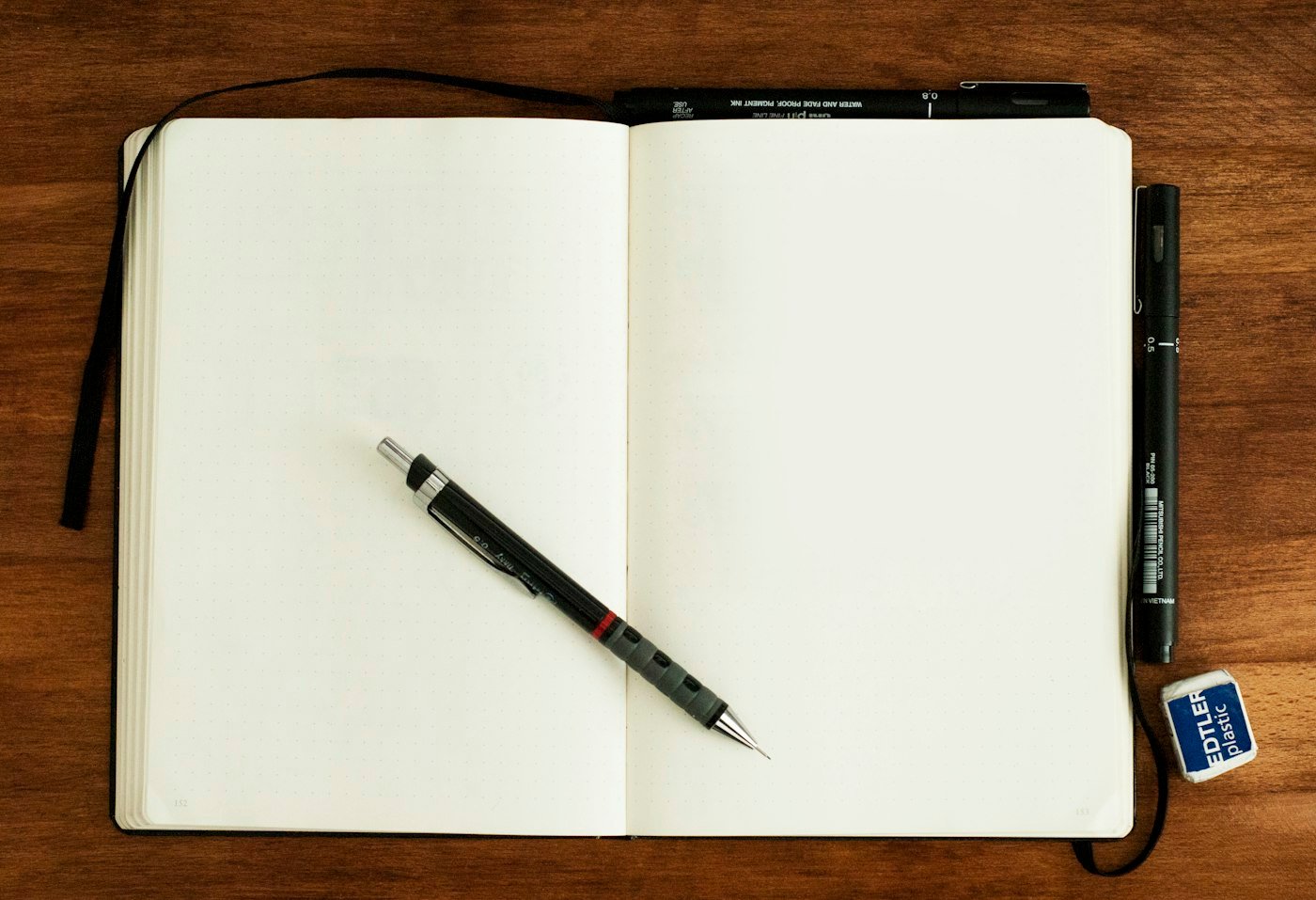 Notebook and pen for listing long-tail keyword ideas